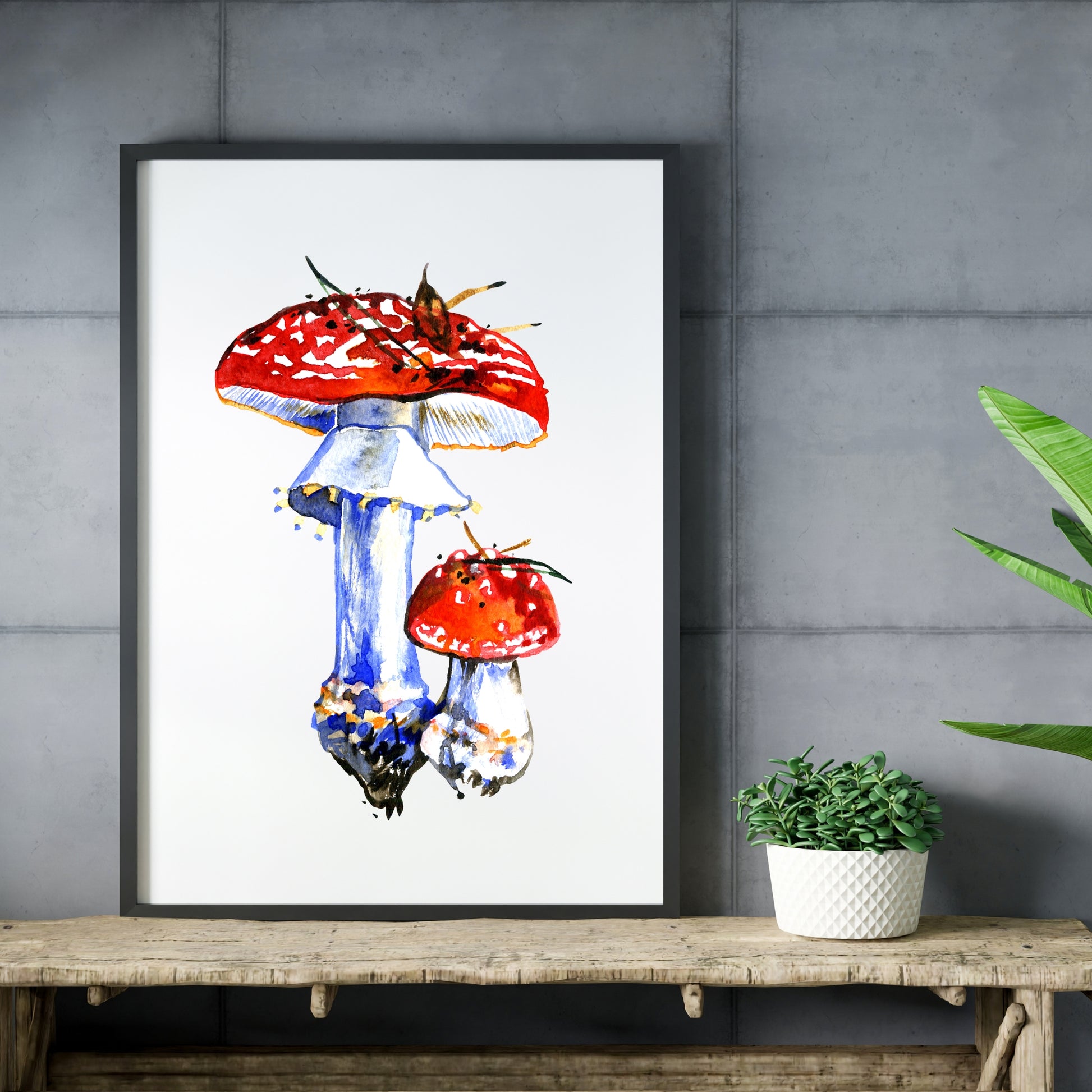 Fly Agaric Mushrooms Watercolor Fine Art Print displayed elegantly on a rustic table, enhancing any artistic space.