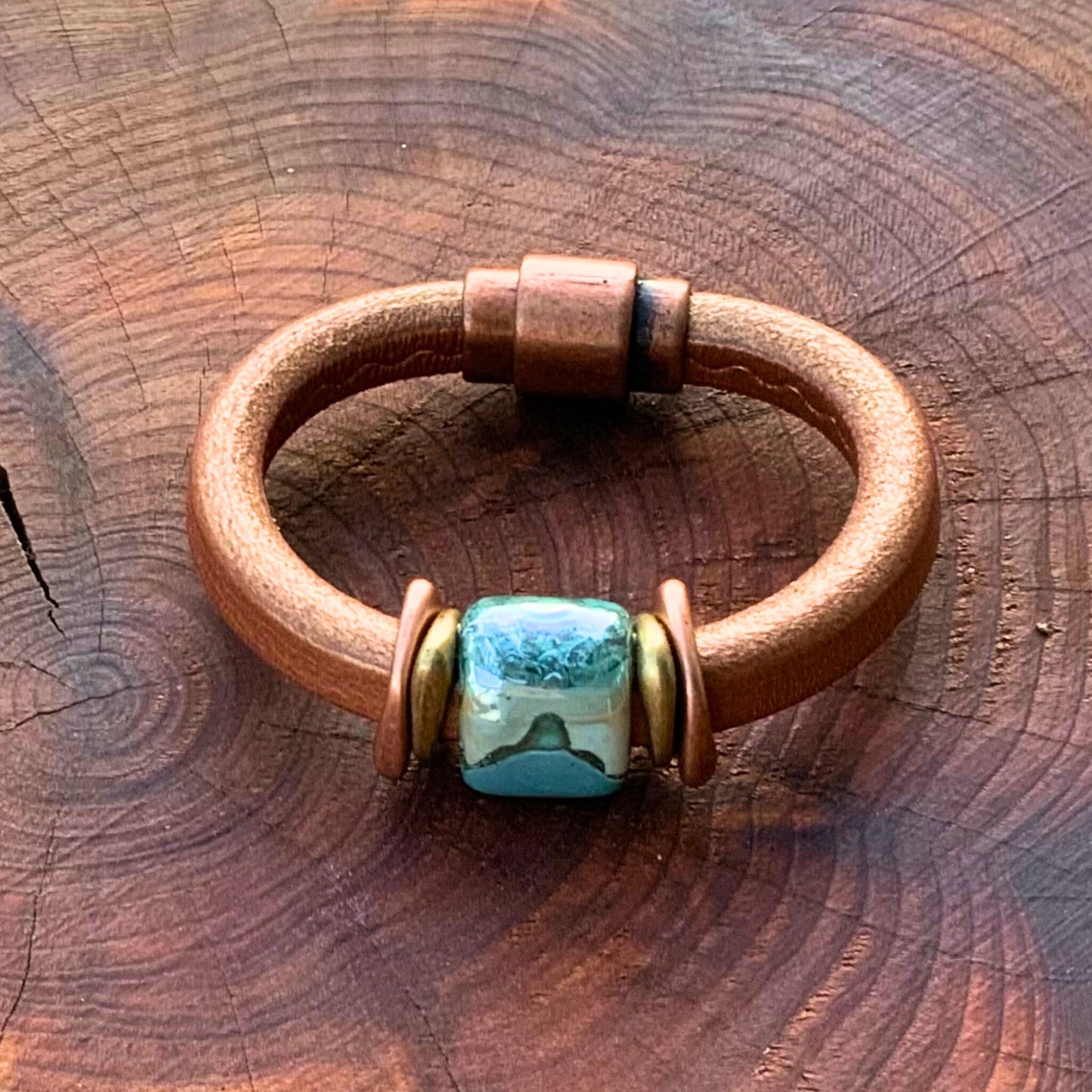 Elegant Tuscan Sunset Ceramic Bracelet in shimmery copper leather with a unique glazed ceramic focal bead.